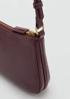 Crossbody bag with charms and rings
